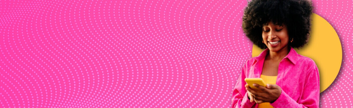 Woman looking down at phone and smiling, representing digital commerce trends and how business is going fully digital.